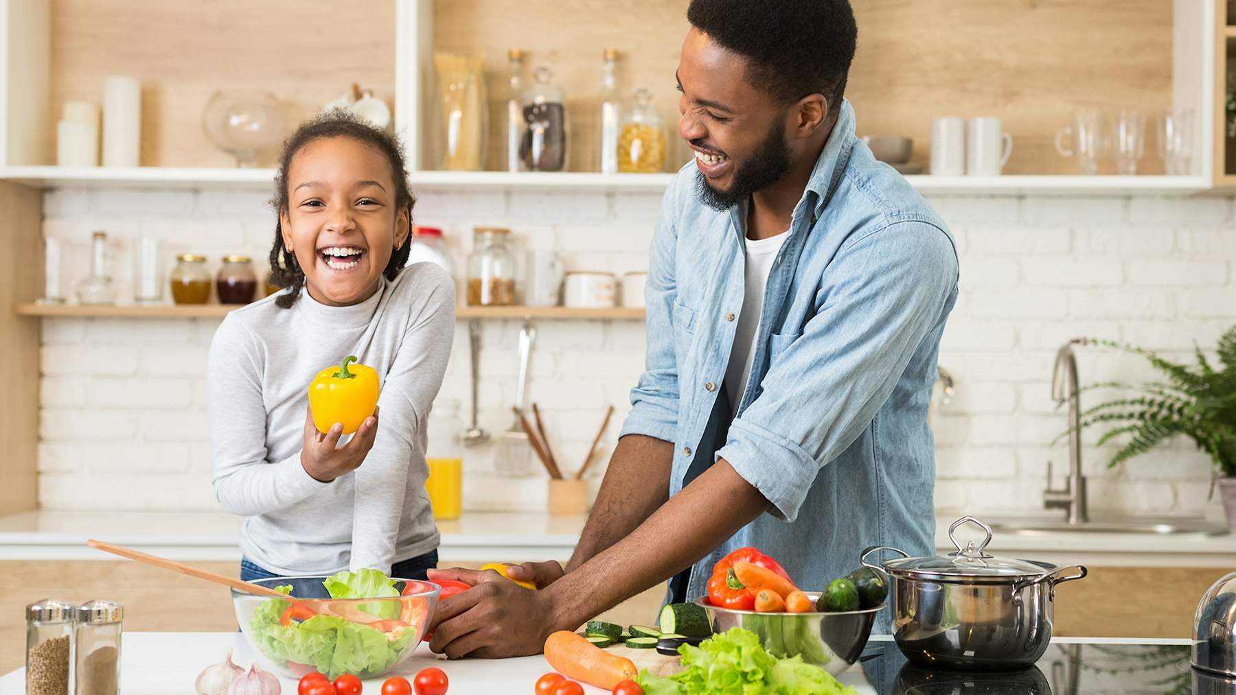 Father and daughter making a salad