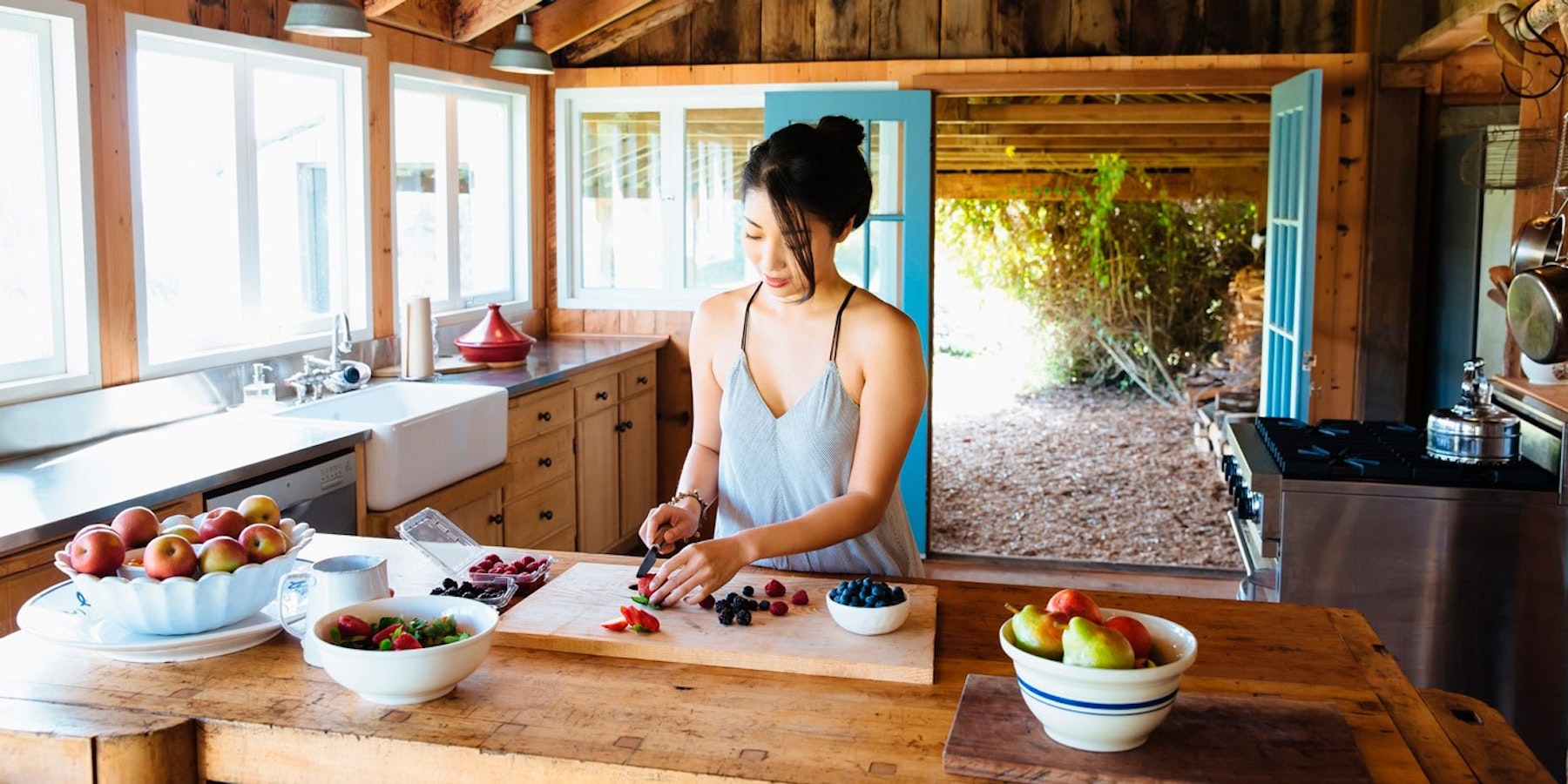 Woman preparing fruit in her kitchen